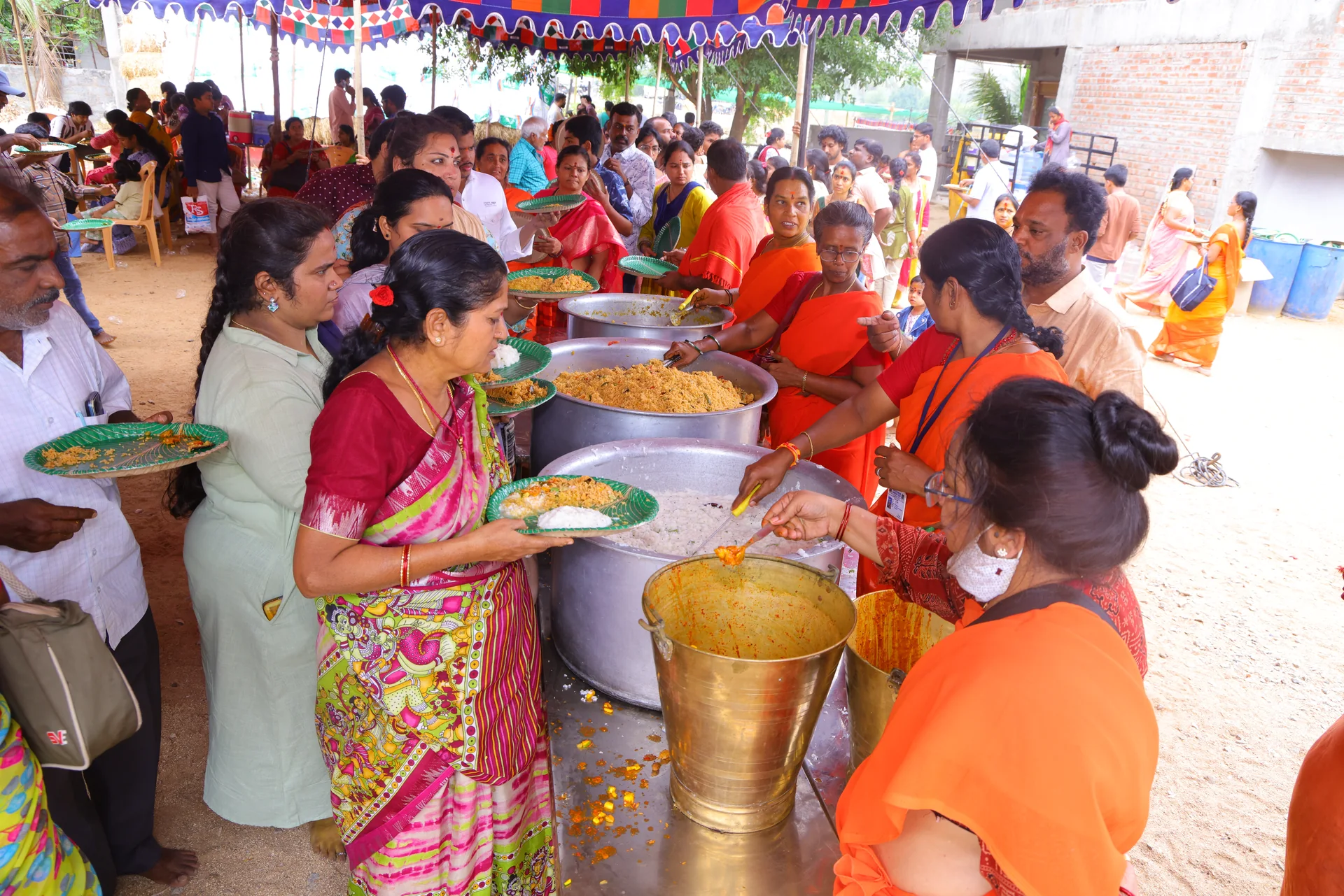 Sri Sakthi Peetam volunteers serving Annadanam to a gathering of devotees